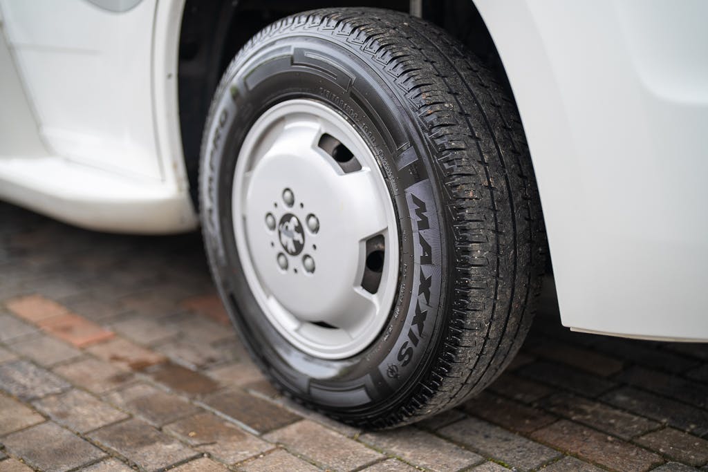 Close-up of a car tire on a brick-paved surface. The tire, with clear tread patterns and "MAXXIS" branding, is part of a white 2007 Auto-Sleepers Sigma EL. The surrounding area includes part of the vehicle and a small portion of the wheel well.