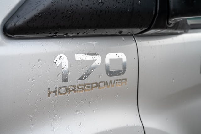 Close-up view of a silver 2019 Benimar Tessoro T486 with the text "170 HORSEPOWER" displayed on the exterior, indicating the vehicle's engine power. The surface of the vehicle is wet with raindrops.