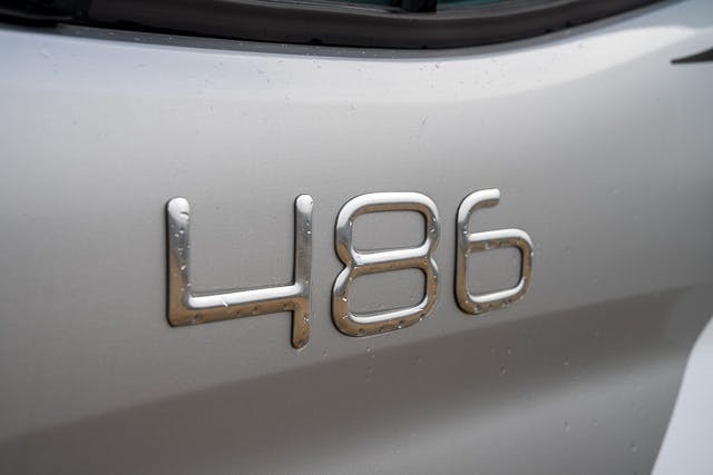 Close-up view of the number "486" in shiny, metallic font on a silver surface of a 2019 Benimar Tessoro T486.