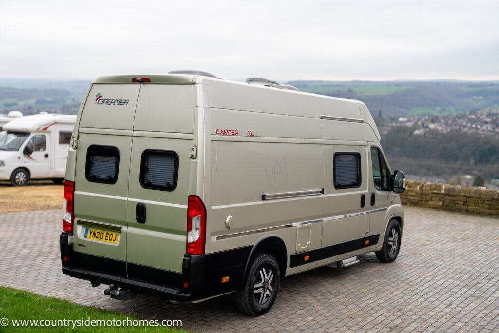A silver 2020 Rapido Dreamer Select Campervan XL with a license plate reading "VN20 EOJ" is parked on a paved surface overlooking a scenic countryside. The rear of the van features black accents and windows. A similar RV is visible in the background. Web address "www.countrysidemotorhomes.com" is in the corner.