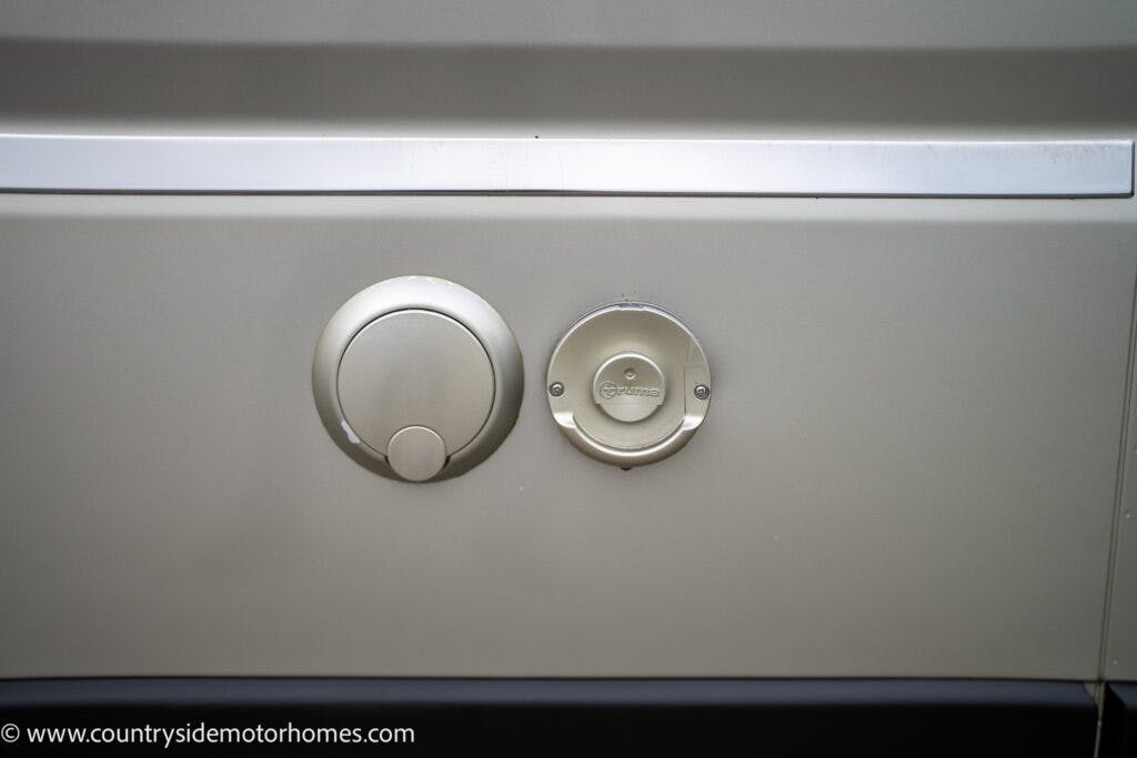A close-up view of the exterior side of a 2020 Rapido Dreamer Select Campervan XL shows two circular ports, one larger and one smaller, set against a beige panel. The larger port is plain, while the smaller one features the Truma logo. The website "www.countrysidemotorhomes.com" is visible.