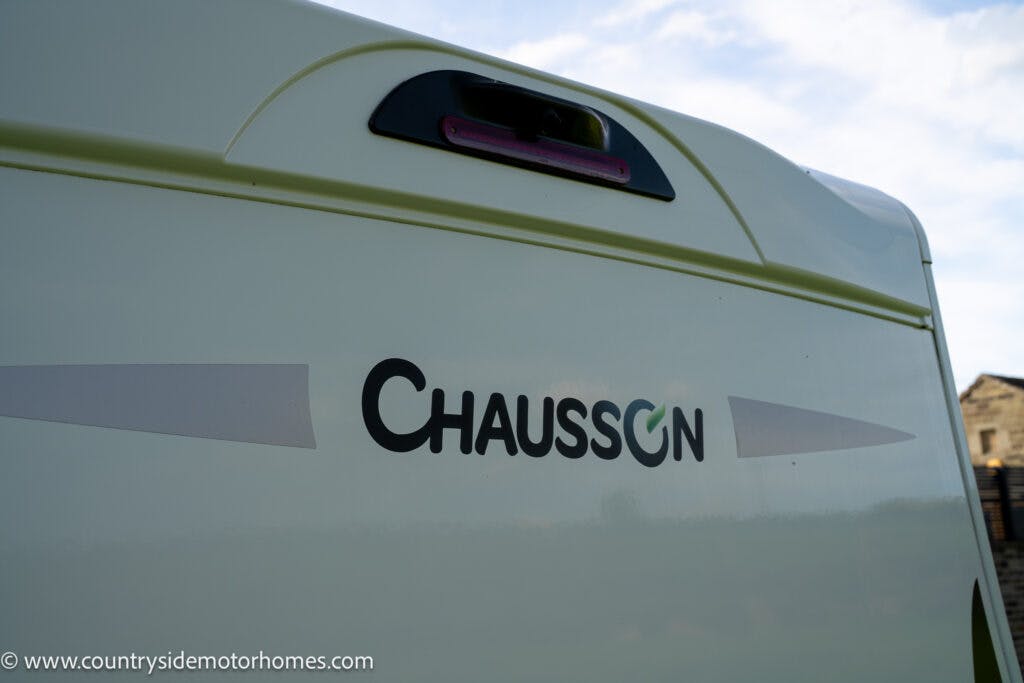 A close-up view of the back of a 2021 Chausson 778 Premium motorhome. The Chausson logo is prominently displayed in the center, with a rear brake light visible above it. The URL www.countrysidemotorhomes.com is visible in the bottom left corner.