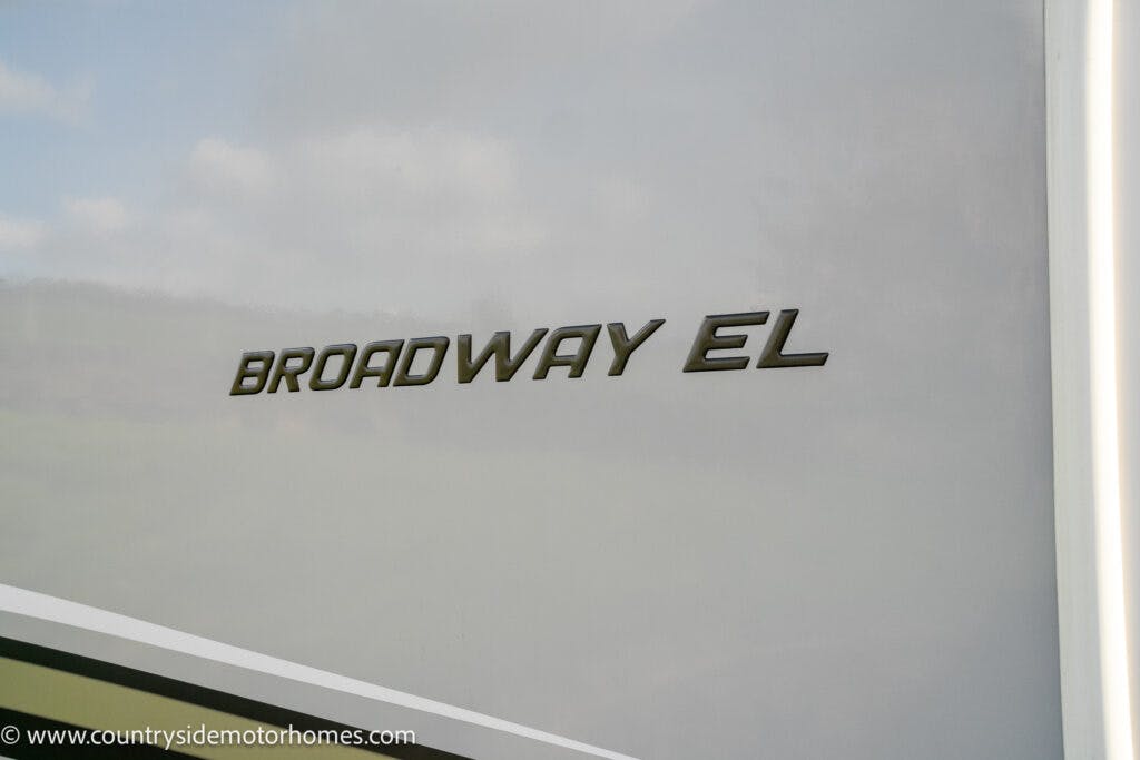 The image showcases the "BROADWAY EL" logo on a smooth, light-colored surface. The website "www.countrysidemotorhomes.com" is visible at the bottom left corner, highlighting the 2021 Auto-Sleepers Broadway EL model.